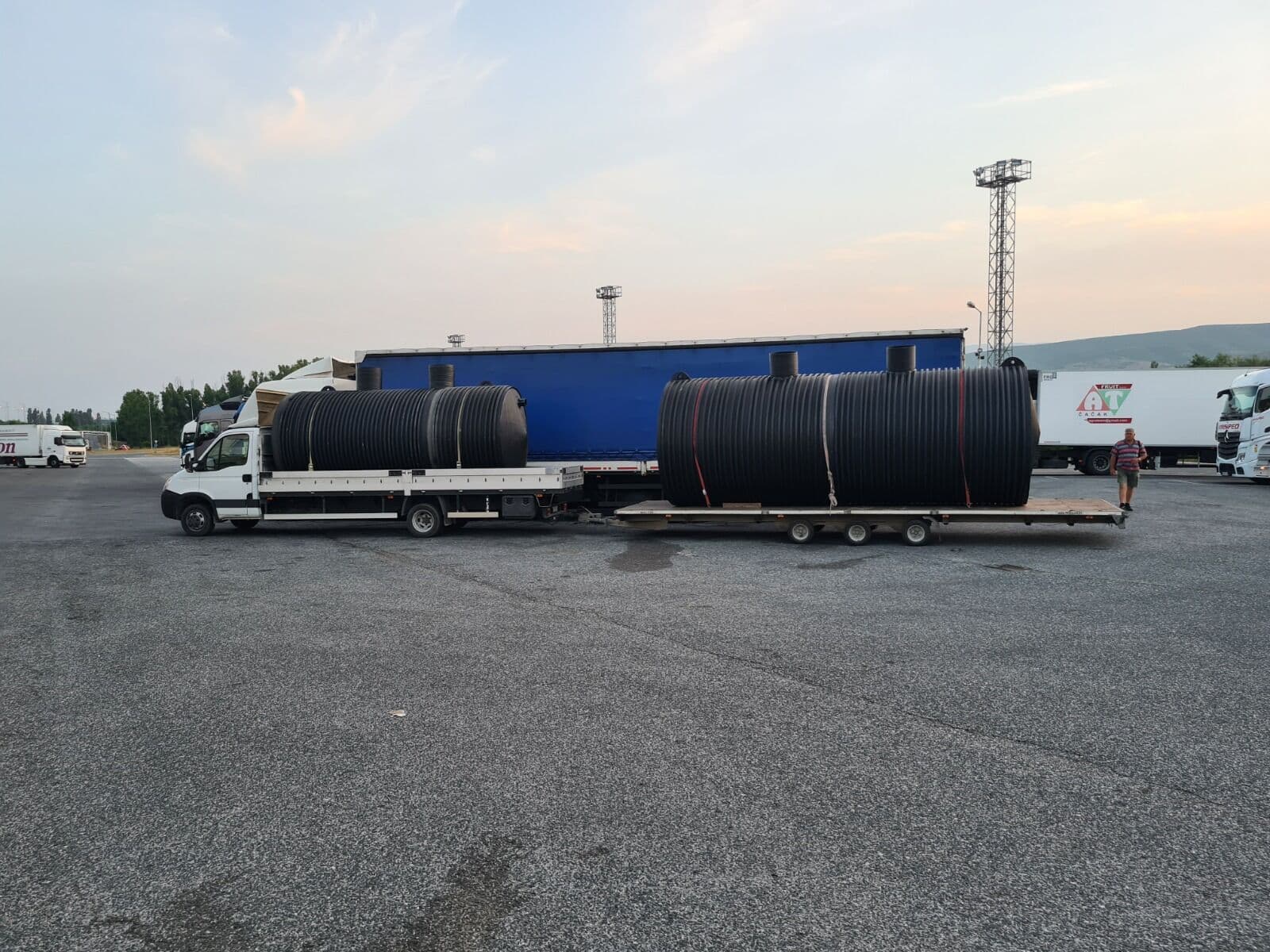 Dva ukopna rezervoara sa grlima na dva kamiona na parkingu